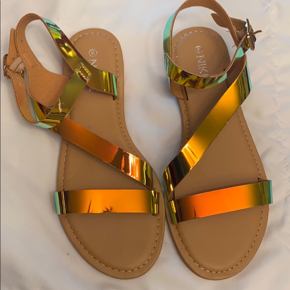Gold metallic sandals .